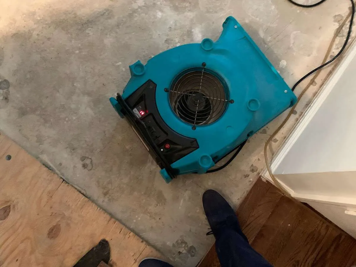 Air mover drying subfloor during Commercial Water Damage Restoration in Fruitport
